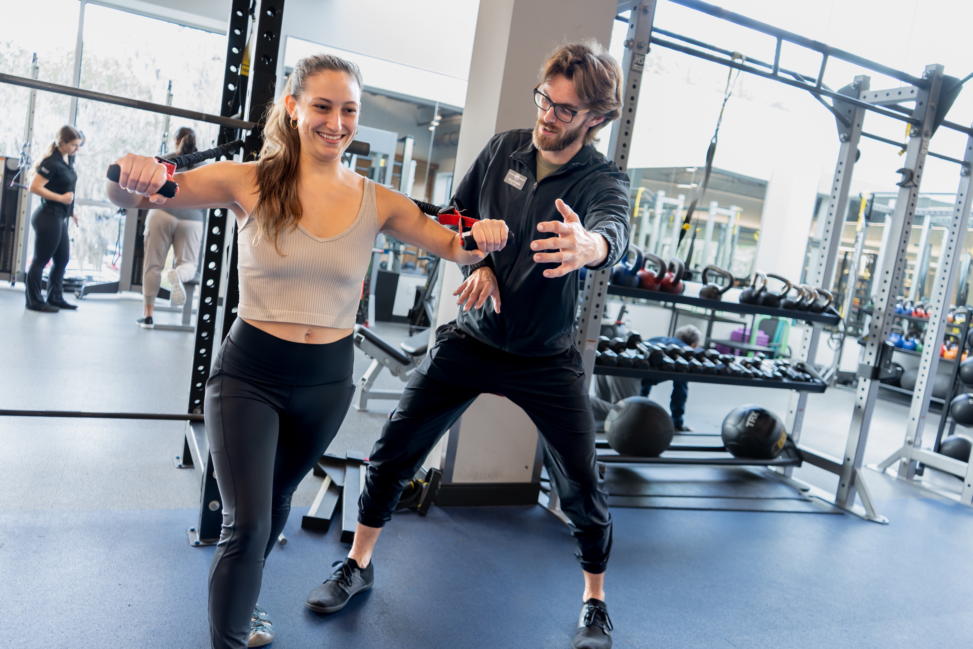 GHF Personal Trainer guiding client through express cable workout