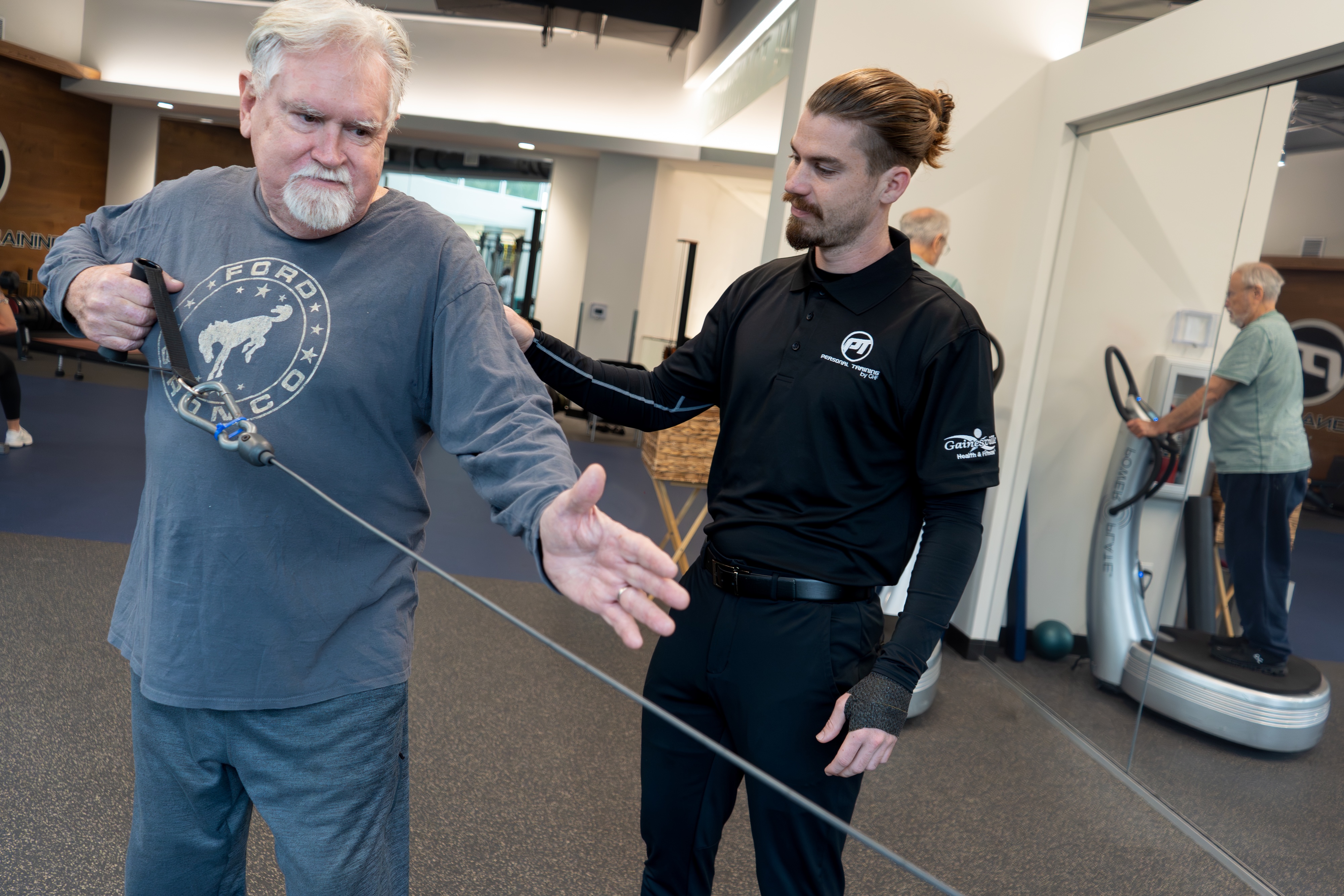 GHF Personal Trainer assisting in upper body workout