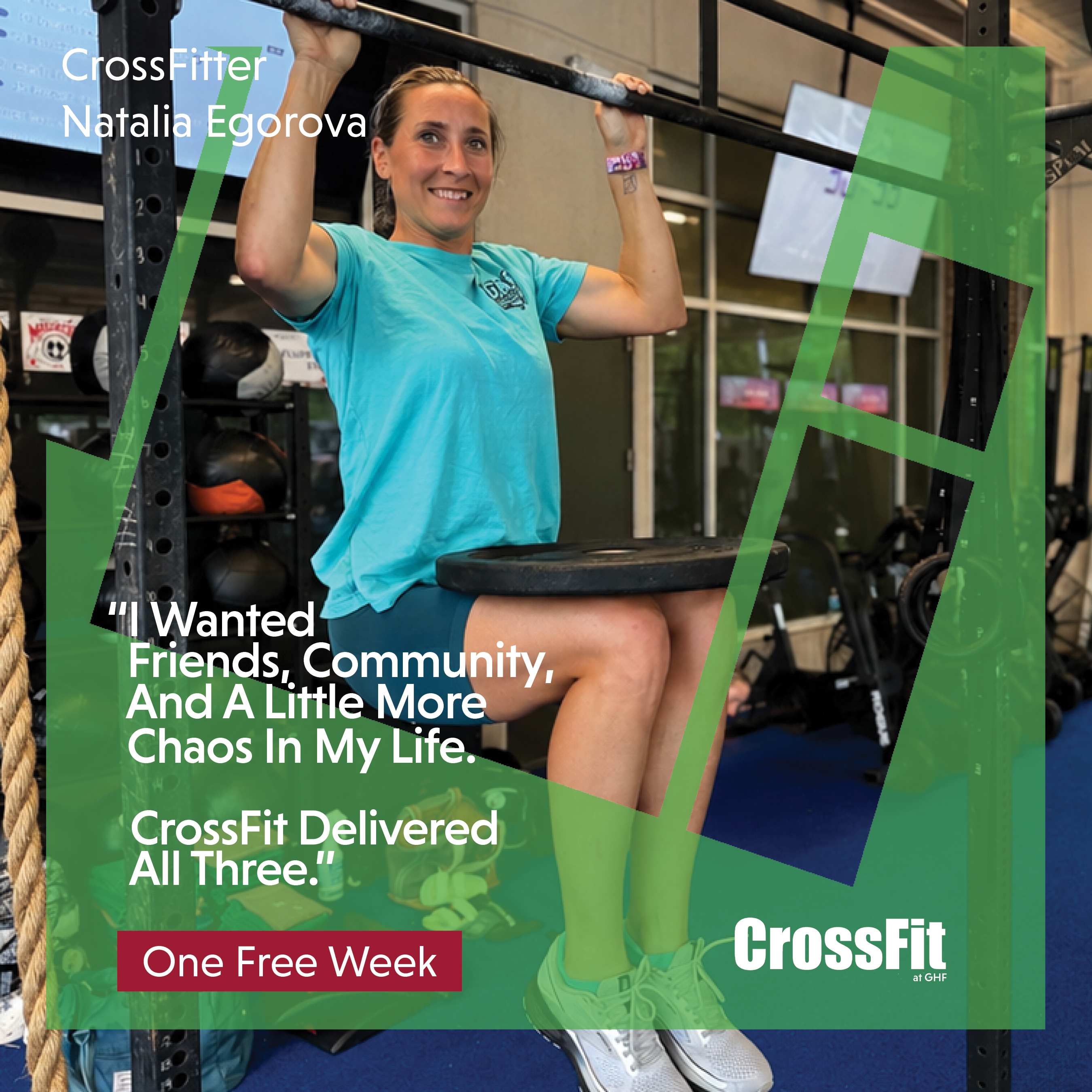 woman doing a deadhang with a plate at ghf crossfit on the turf 