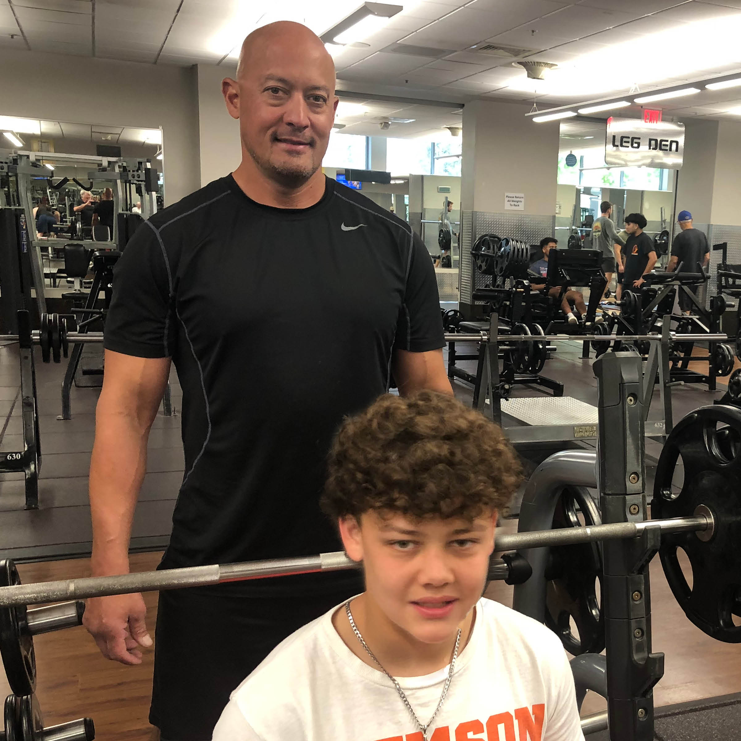 father and son committed to fitness at the gym
