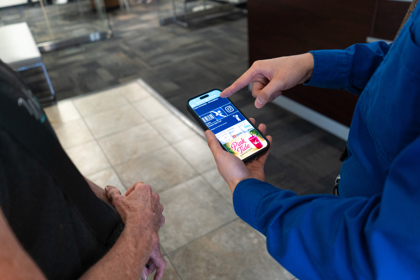 ghf staff showing a member how to use ghf app