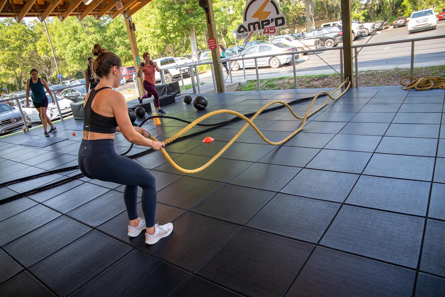 woman doing battle ropes at gainesville health & fitness
