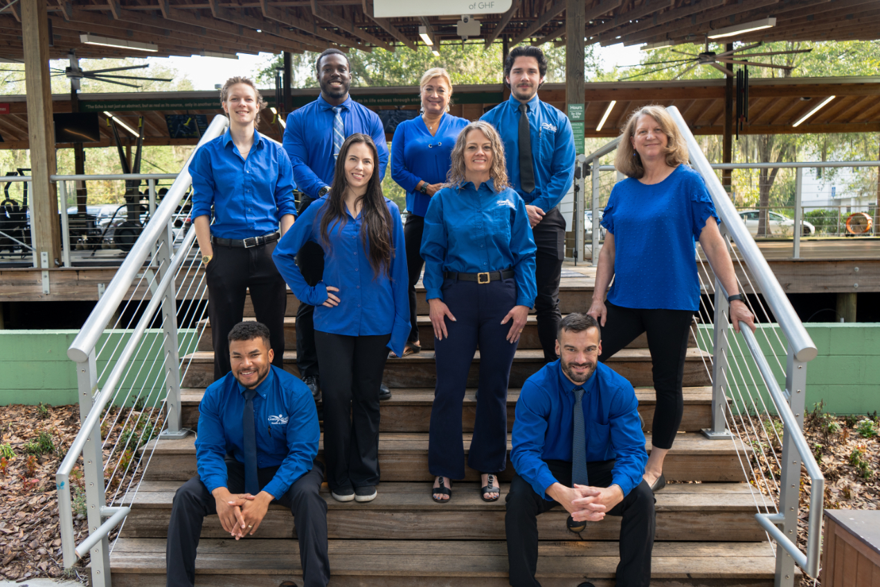 GHF staff sitting on the stairs to our outdoor pavilion