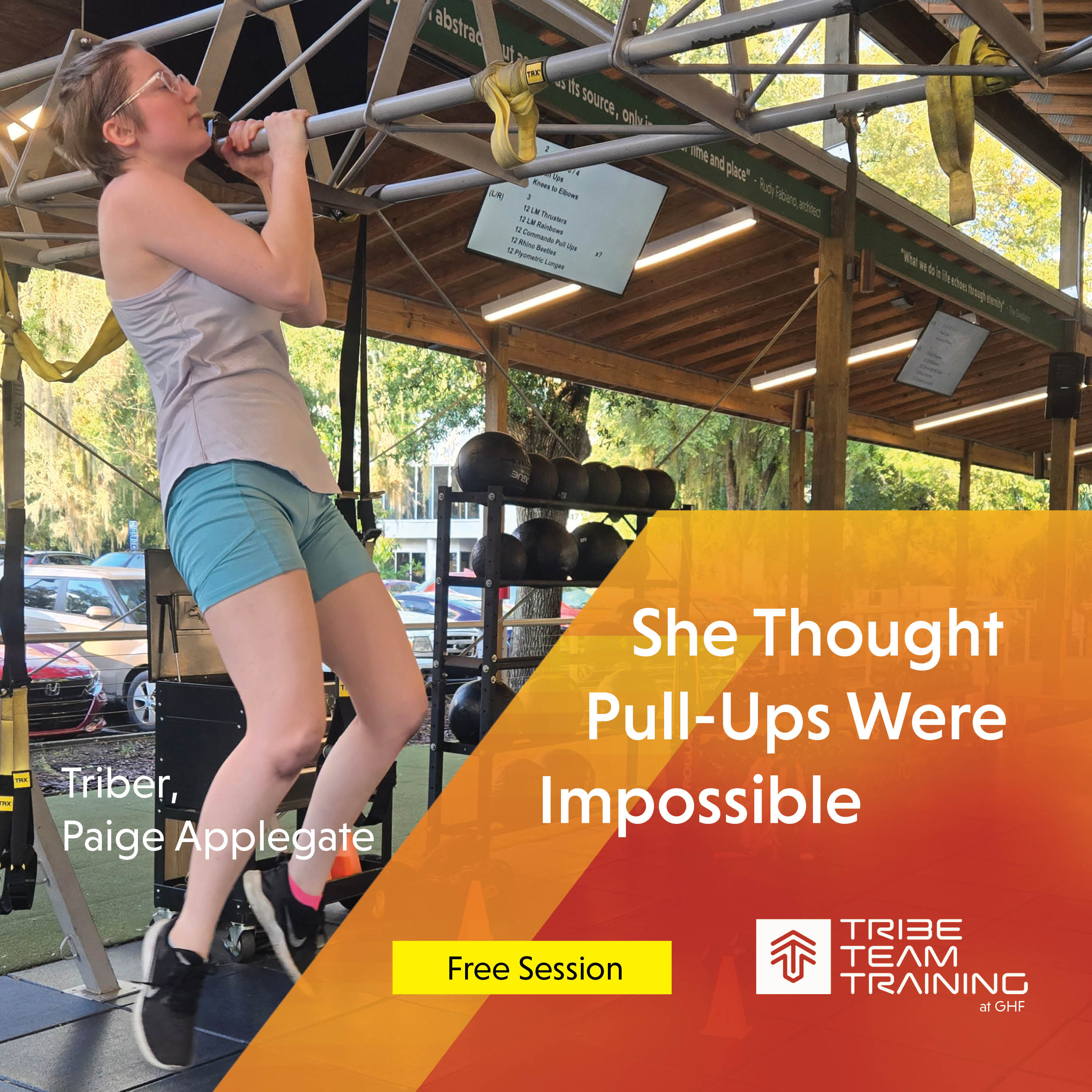 woman doing a pull up in small group training class